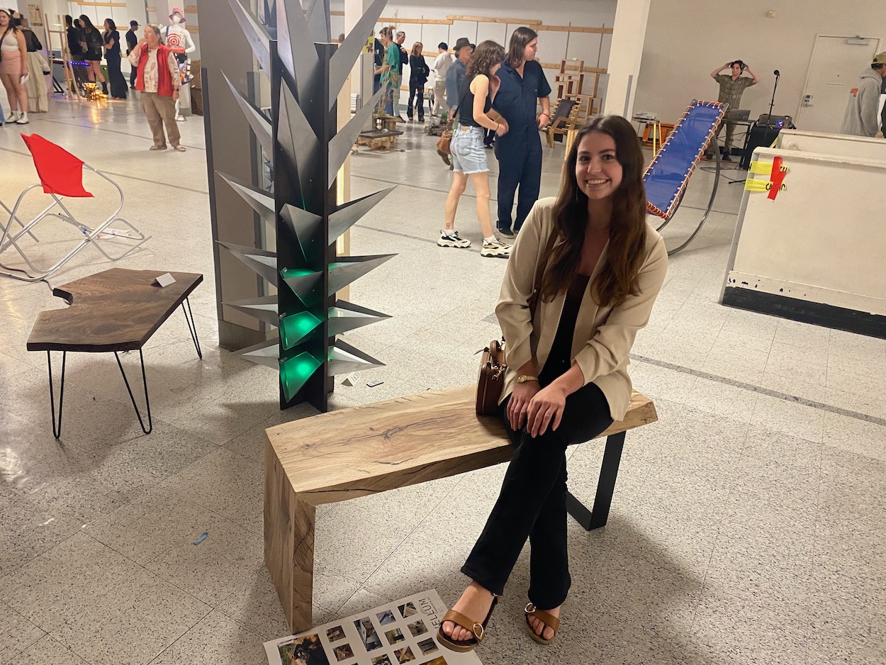 Architecture Senior Mariah Boche sat on her oak wood bench which she designed for the competition. 